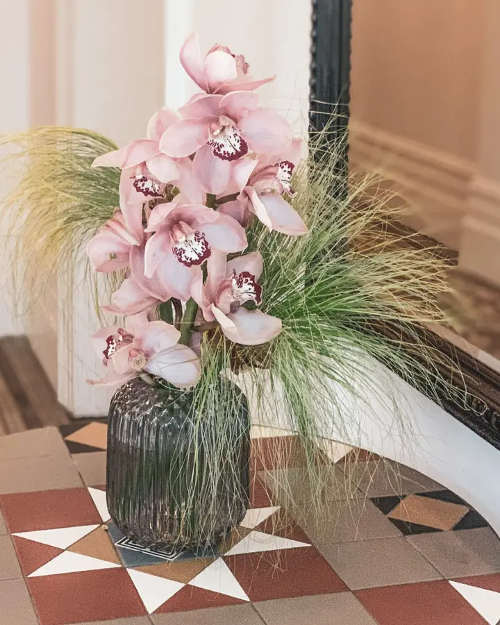 Pink cymbidium in glass