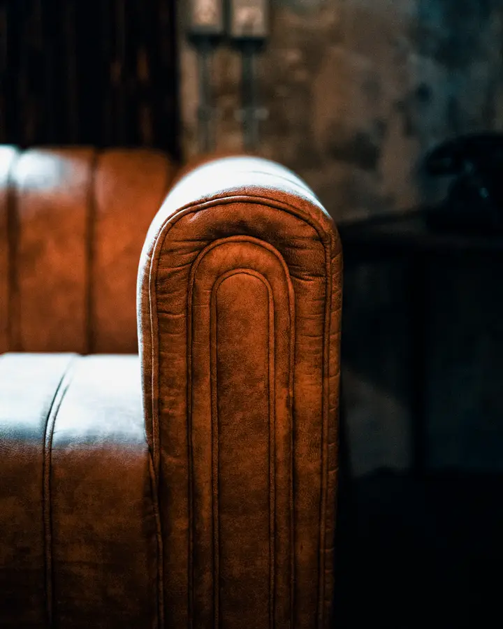 Arch-arm leather armchair